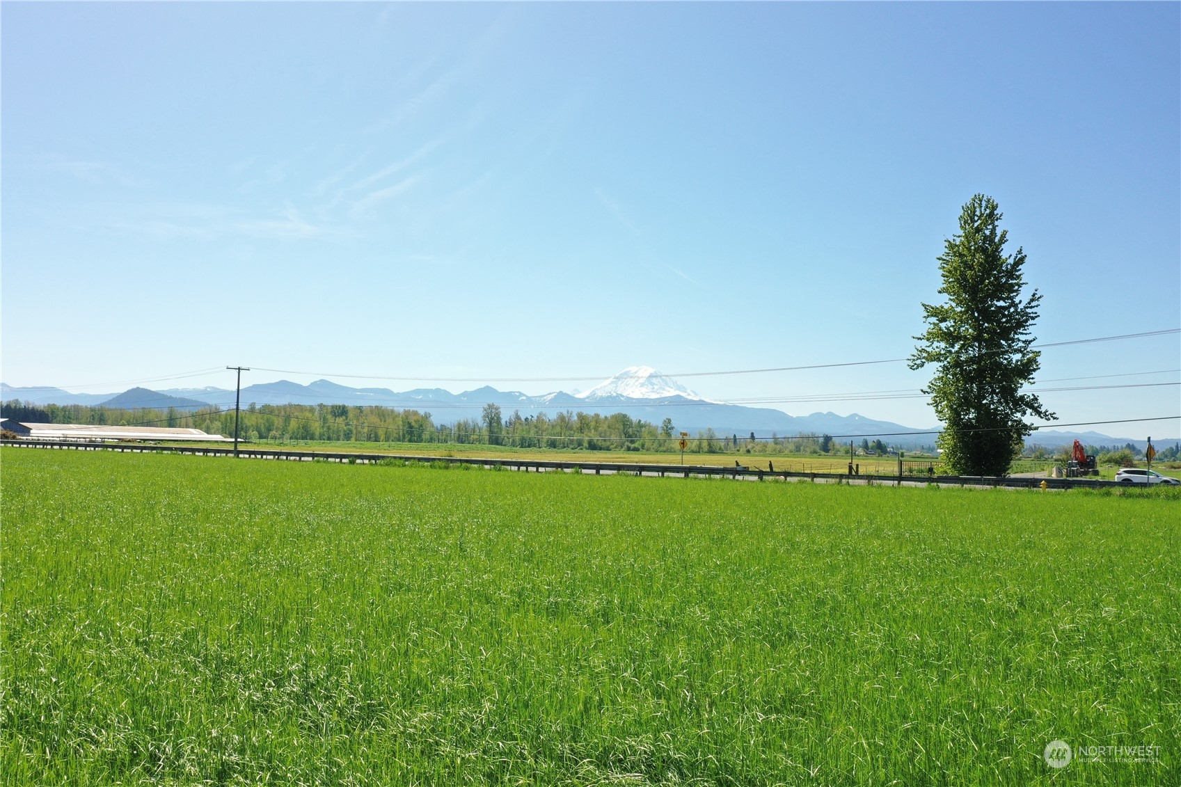 a view of a green field with an ocean view