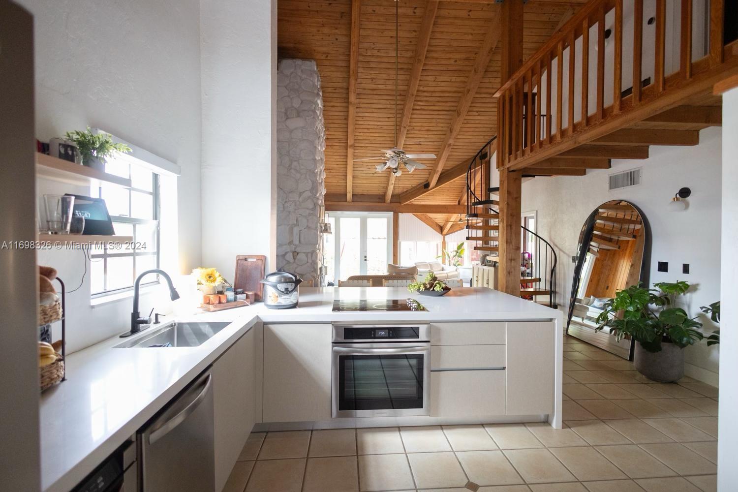 a kitchen with a sink stove and cabinets