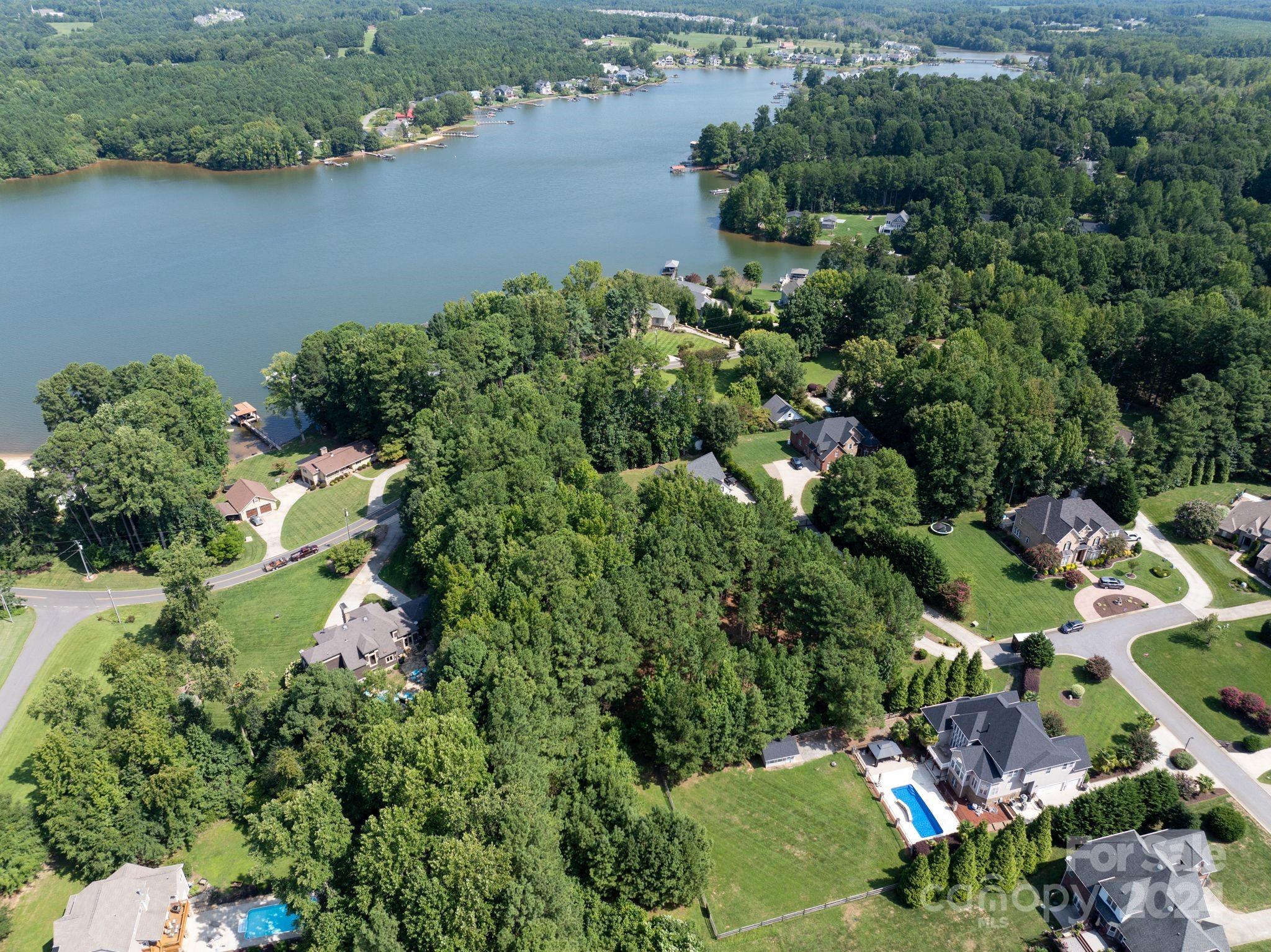 an aerial view of residential house with outdoor space and lake view