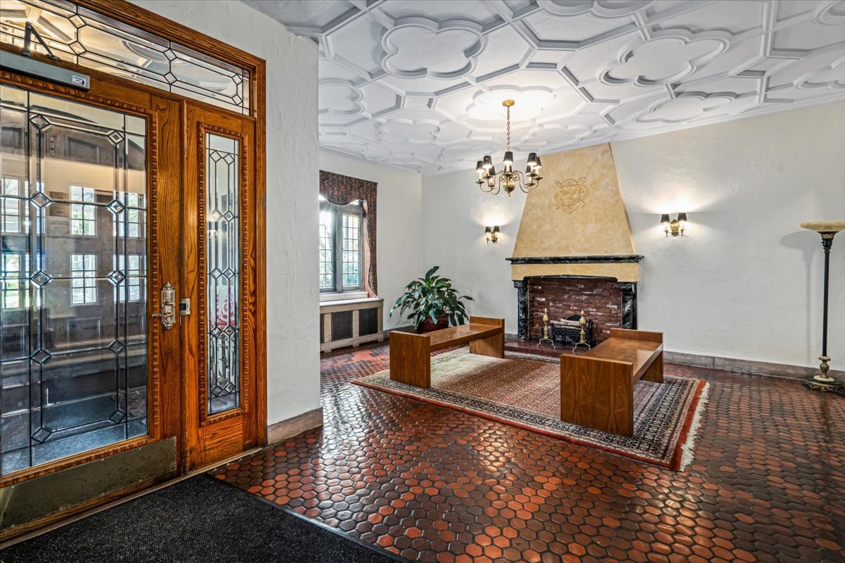 a living room with fireplace furniture and a chandelier