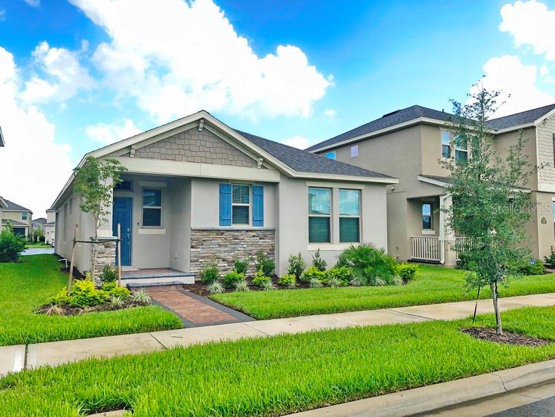 a front view of a house with a garden and plants