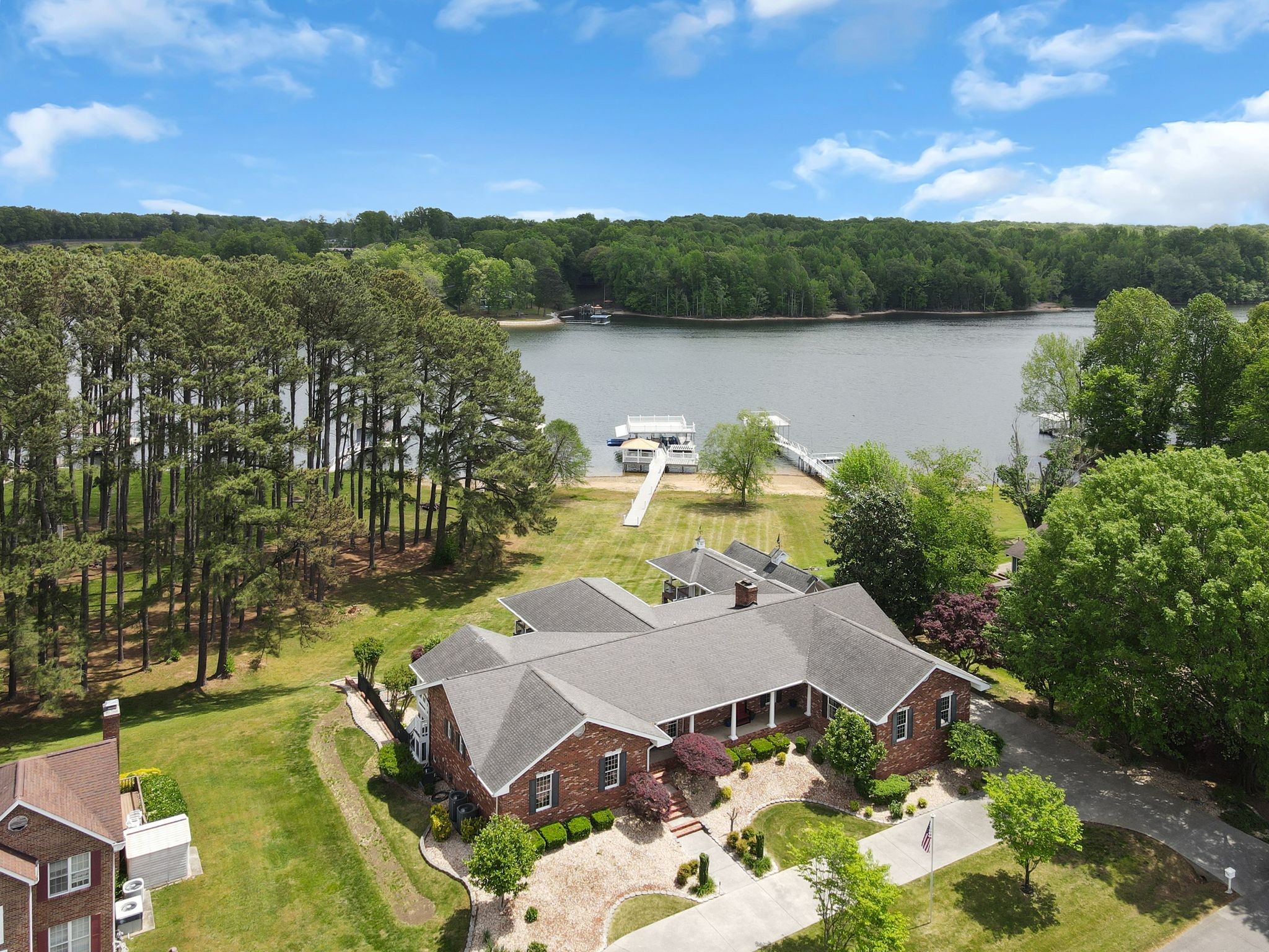 an aerial view of a house with a lake view