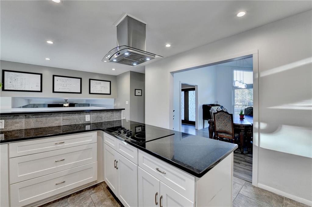 a kitchen with granite countertop stainless steel appliances a sink and cabinets