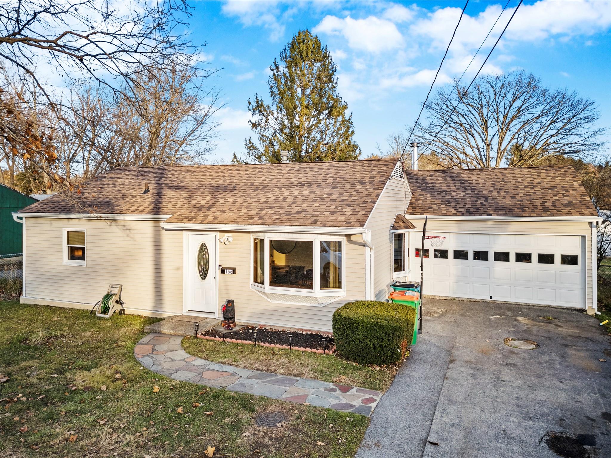 View of front of home featuring a garage and a front lawn