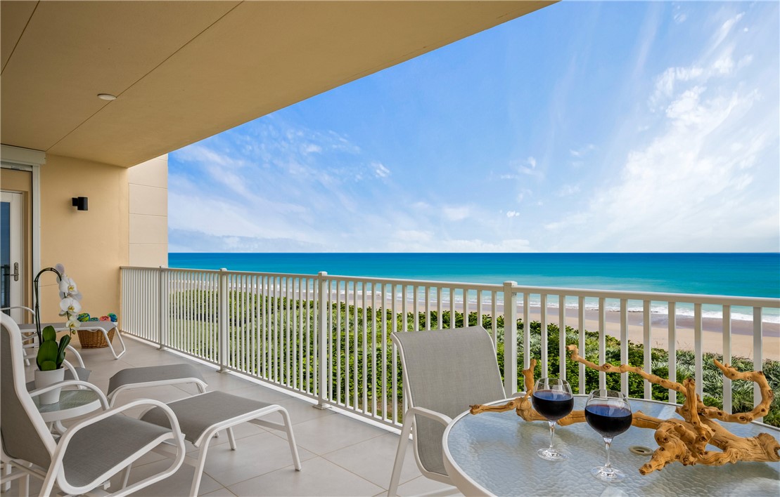 a balcony with table and chairs