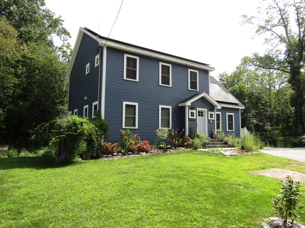 a front view of house with yard and green space