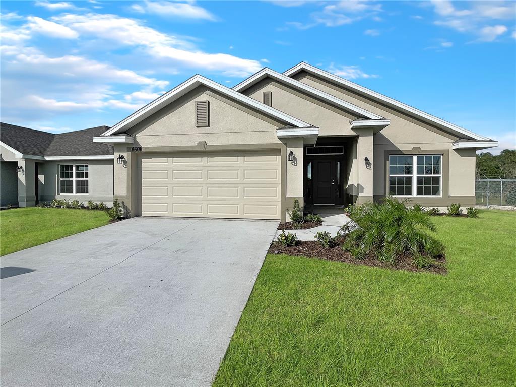 a front view of house with yard and green space