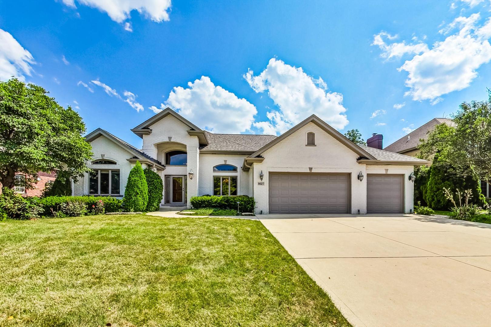 a front view of house with yard garage and green space