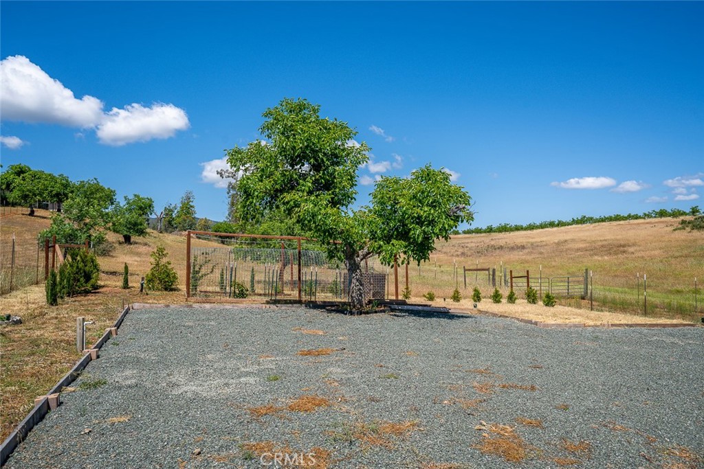 a view of a dirt road with a building in the background