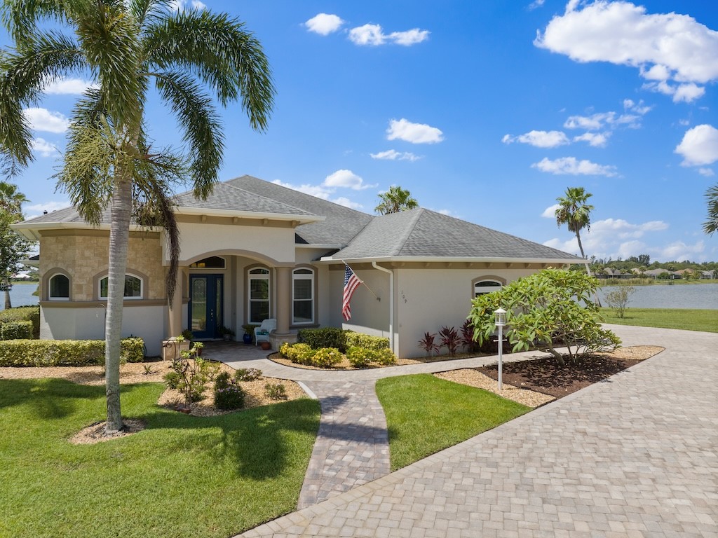 a front view of a house with swimming pool garden and patio