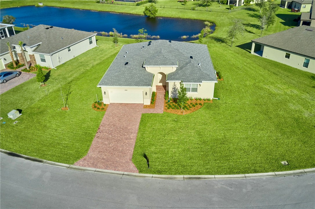 an aerial view of a house with a garden and trees