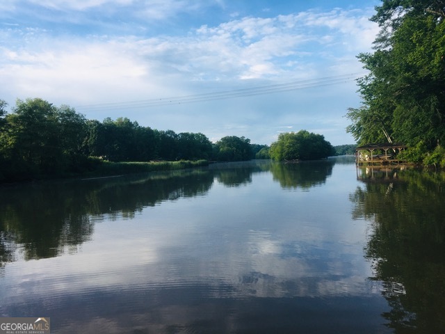 a view of a lake with houses in the background