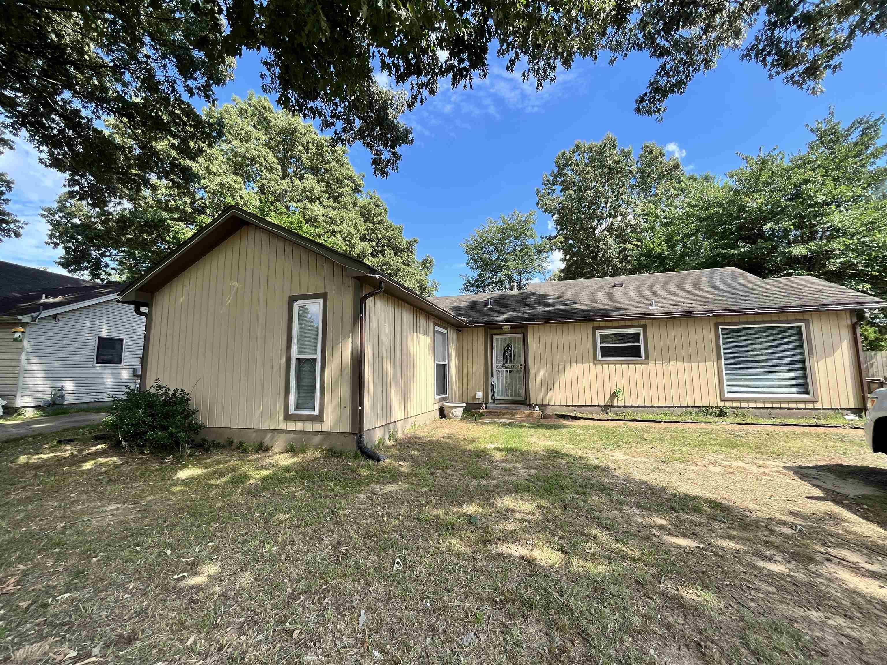 a house that has a tree in front of it