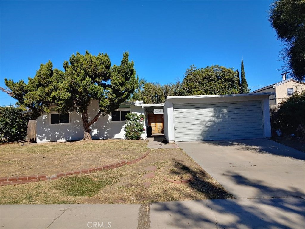 a view of a house with a tree in the background