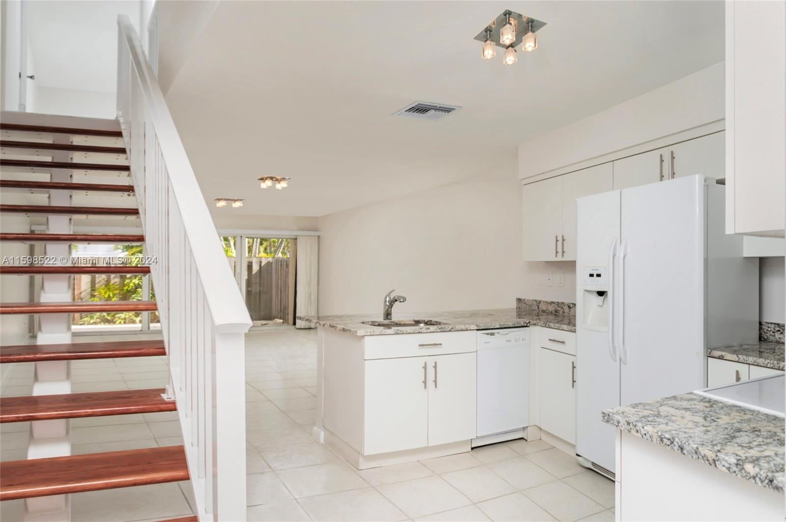 a kitchen with a sink stove and refrigerator