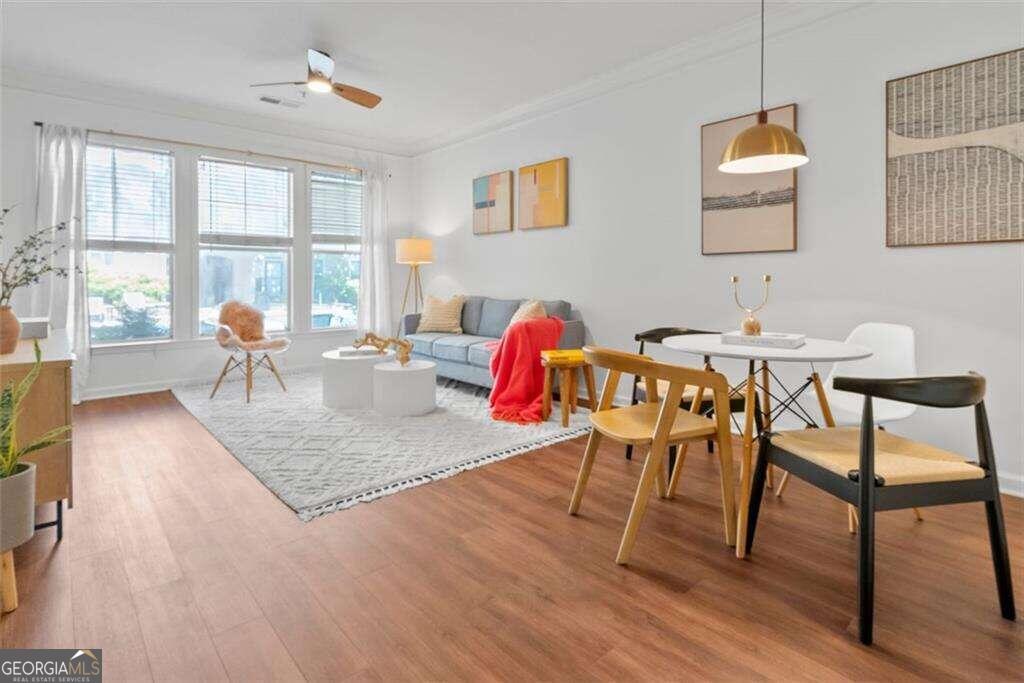 a dining room with furniture and wooden floor