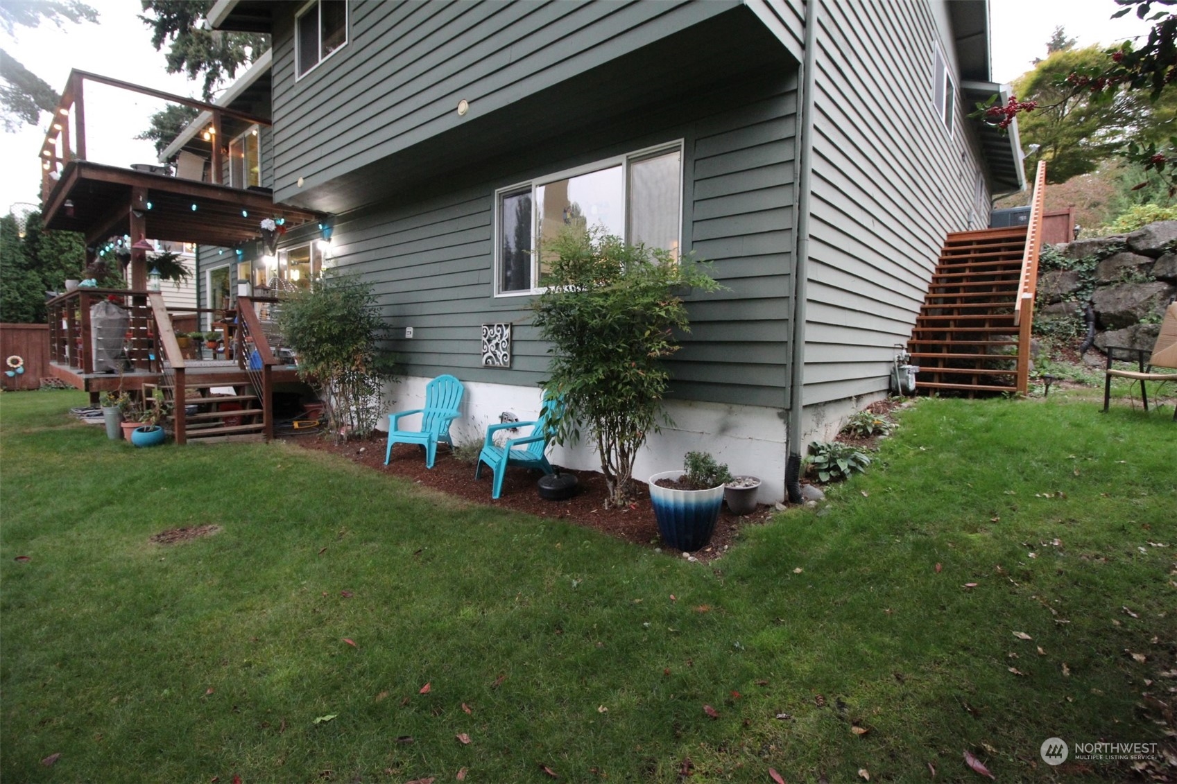 a view of a backyard with table and chairs and a fire pit