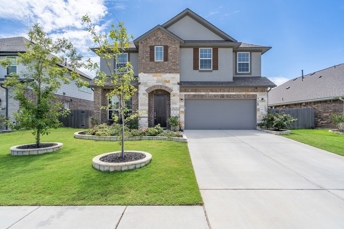 a front view of a house with a yard