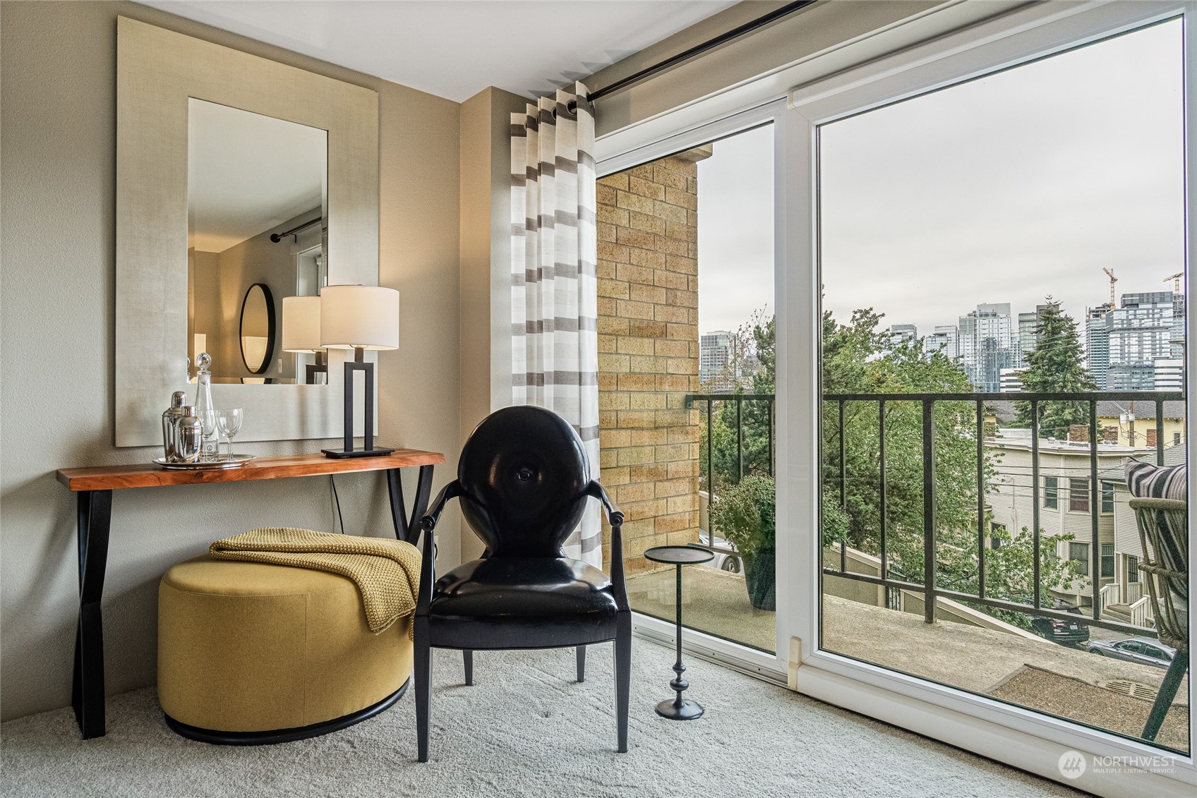 a living room with furniture and a floor to ceiling window