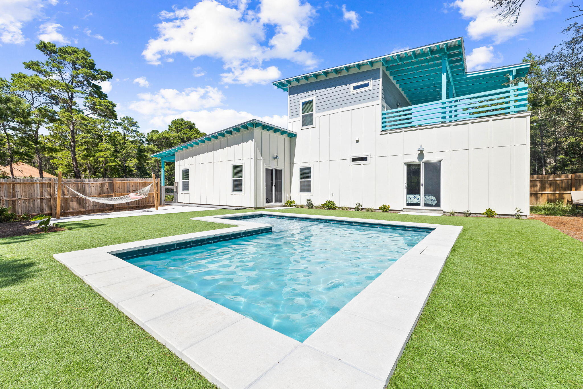 a view of a house with swimming pool and a yard