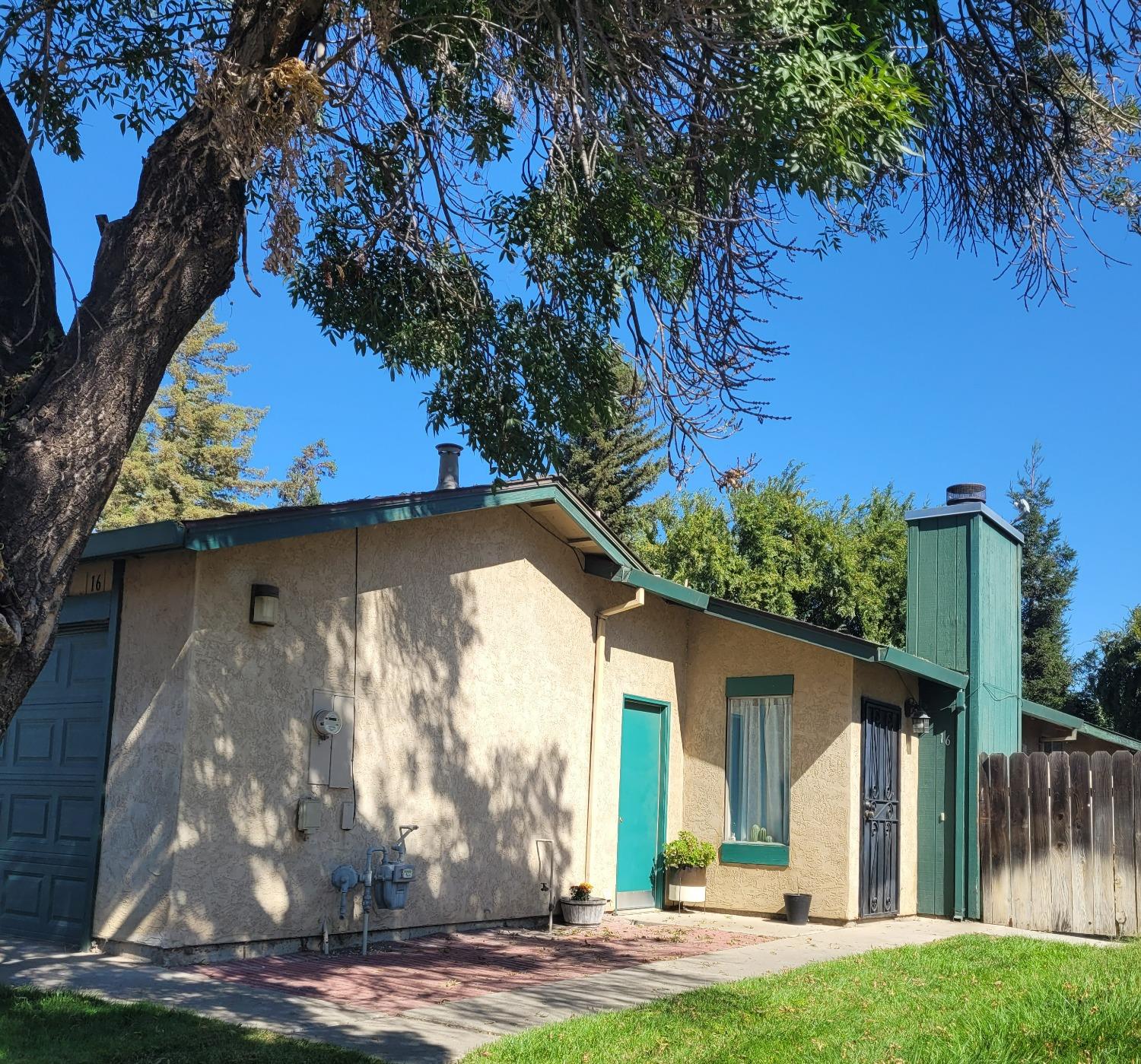 a view of a house with a tree in a yard