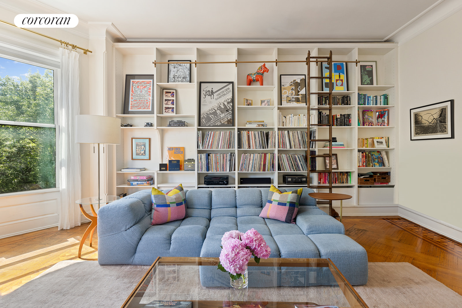 a living room with furniture and floor to ceiling windows