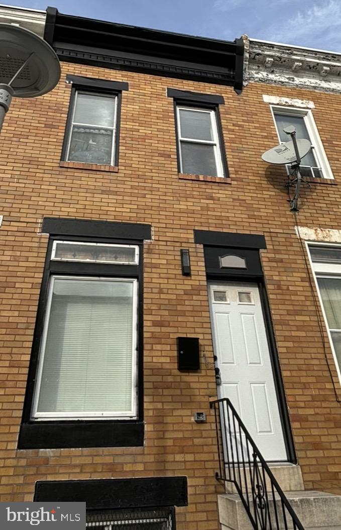 a brick house with four windows