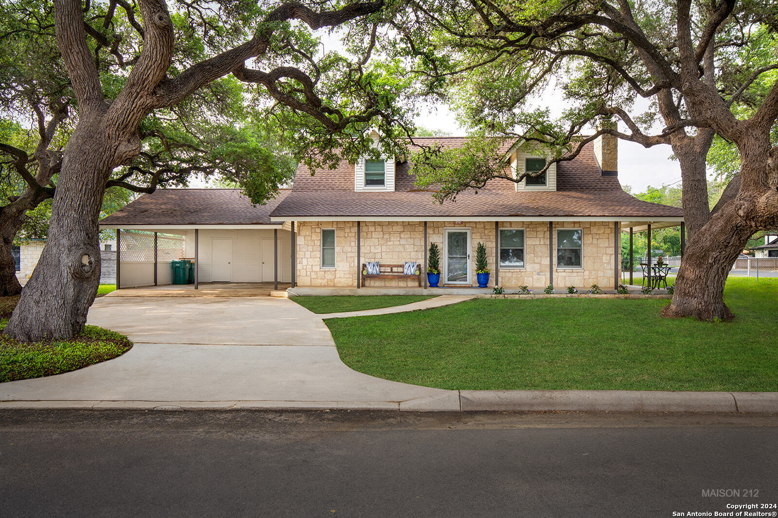 a front view of a house with a garden