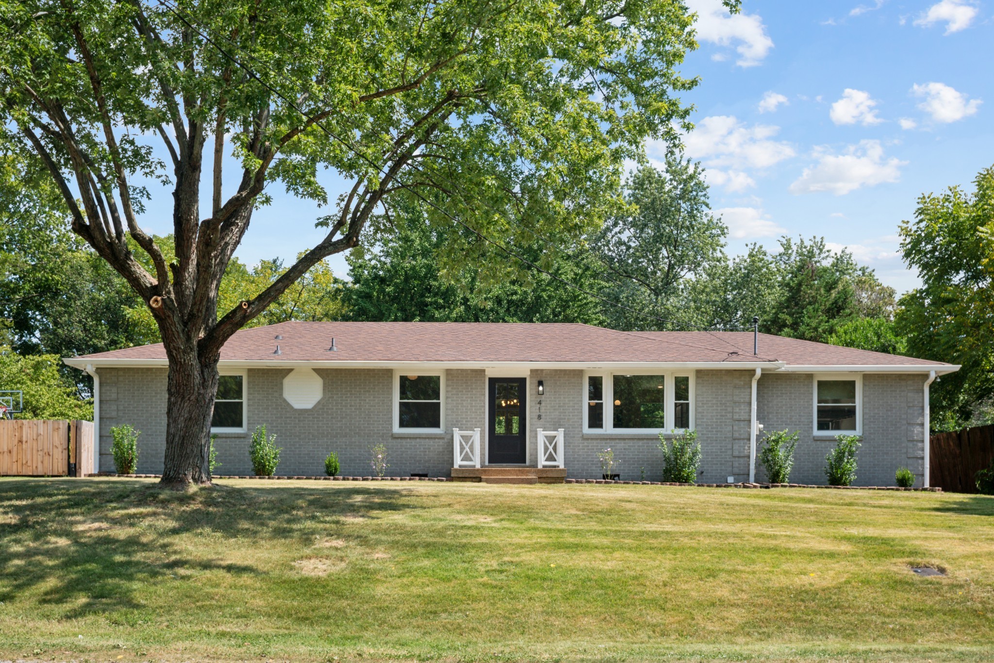 a front view of a house with a garden