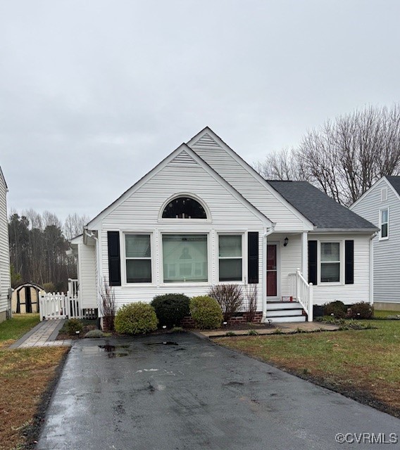 a view of a house with yard and chairs in patio