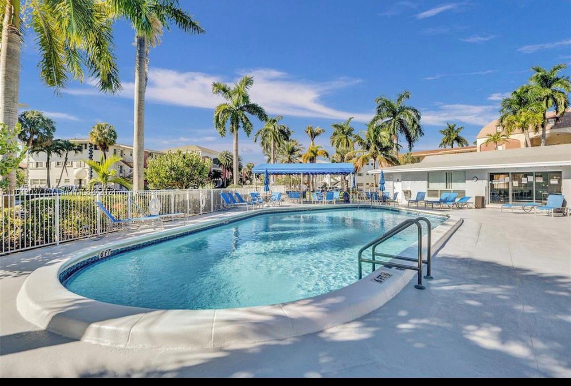 a view of a swimming pool with a patio