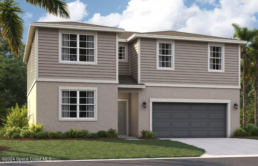 a front view of a house with a yard and garage