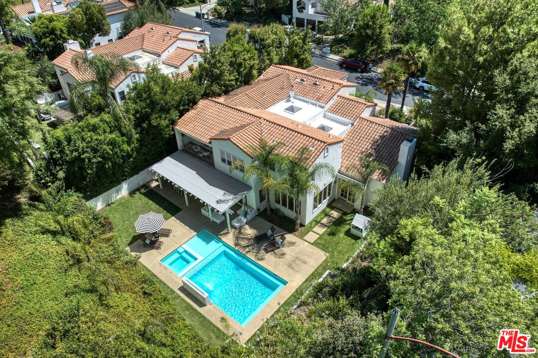 an aerial view of a house with a yard