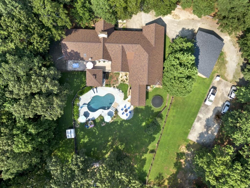 an aerial view of a house with a yard and lots of green space