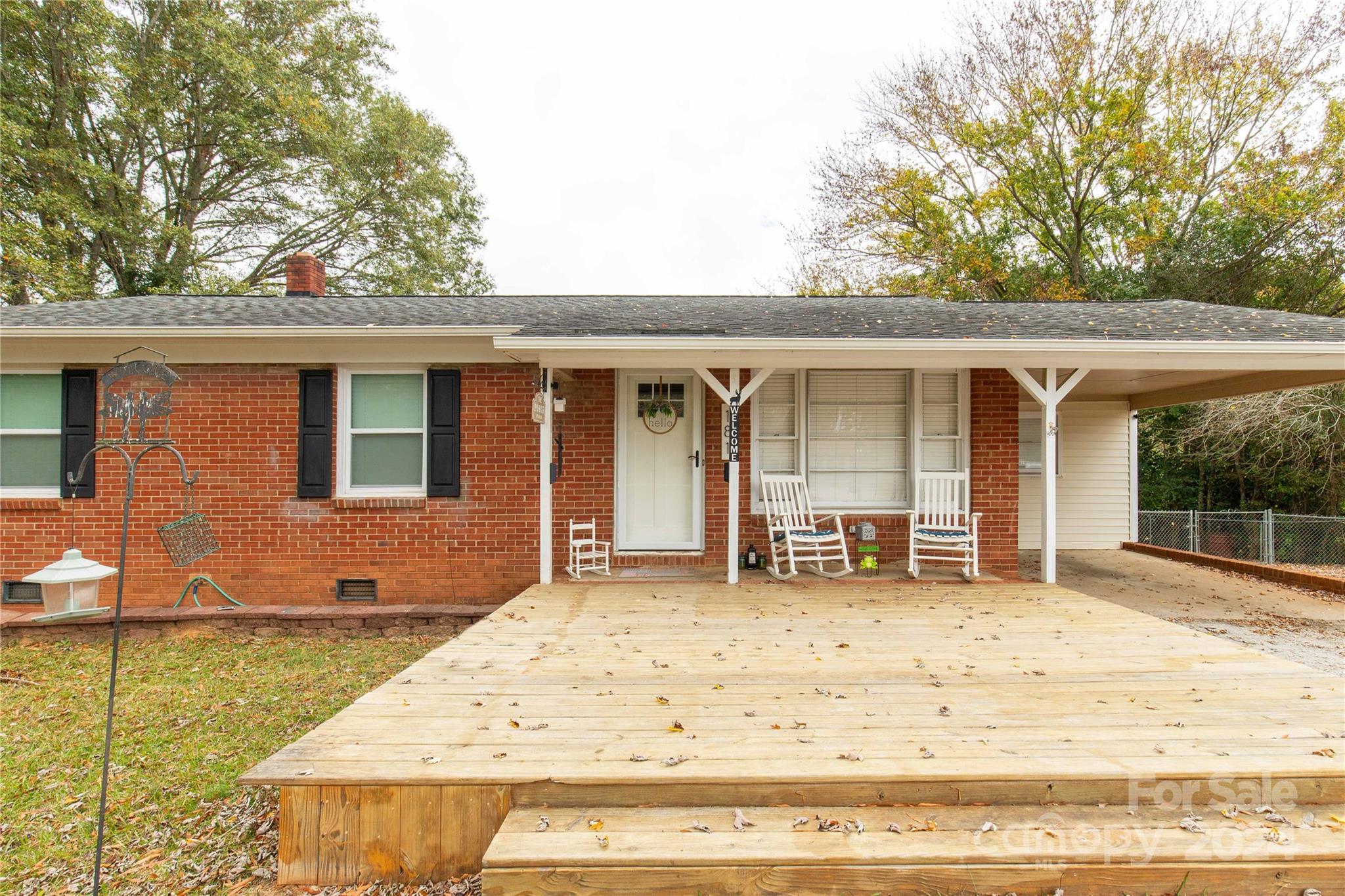 a front view of house with yard outdoor seating and barbeque oven