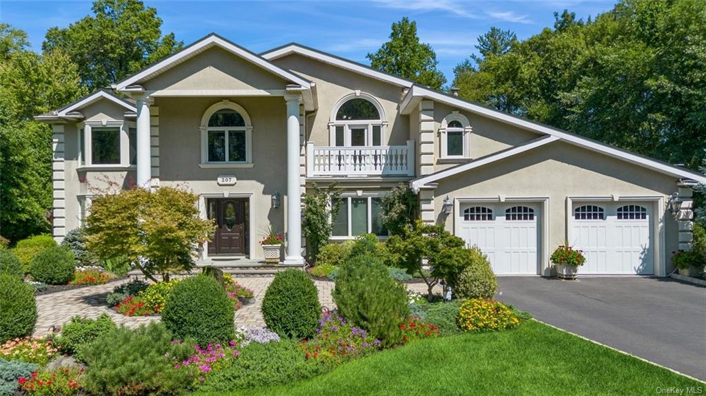 a front view of a house with garden