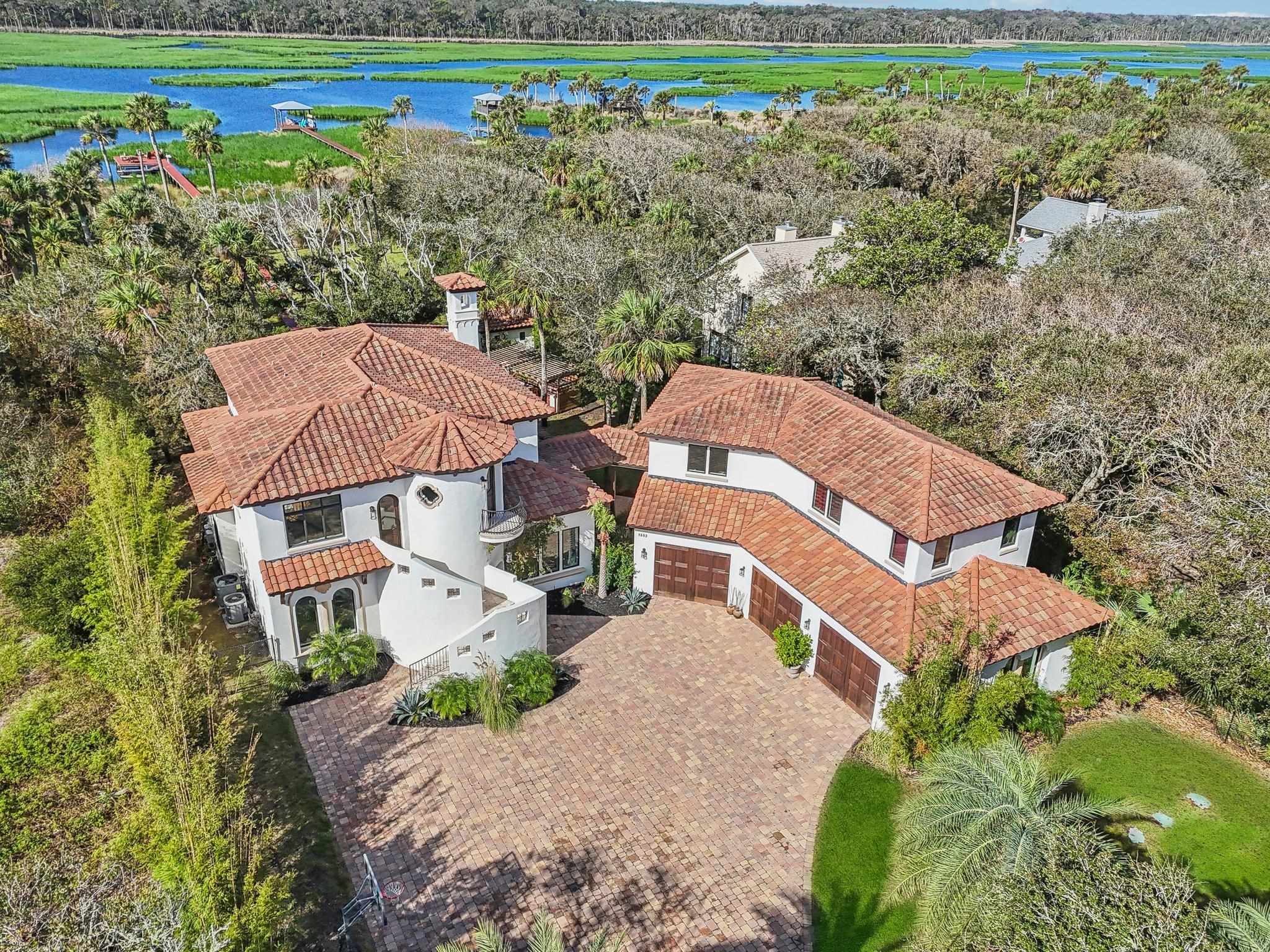 an aerial view of a house with a yard