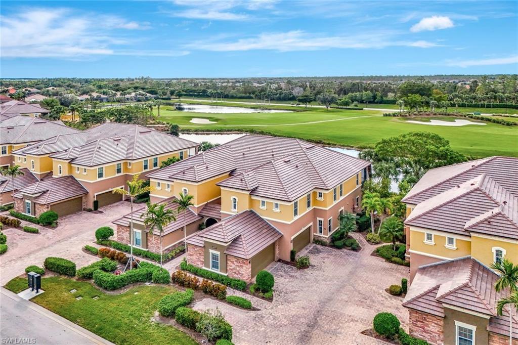 an aerial view of residential houses with outdoor space and ocean view