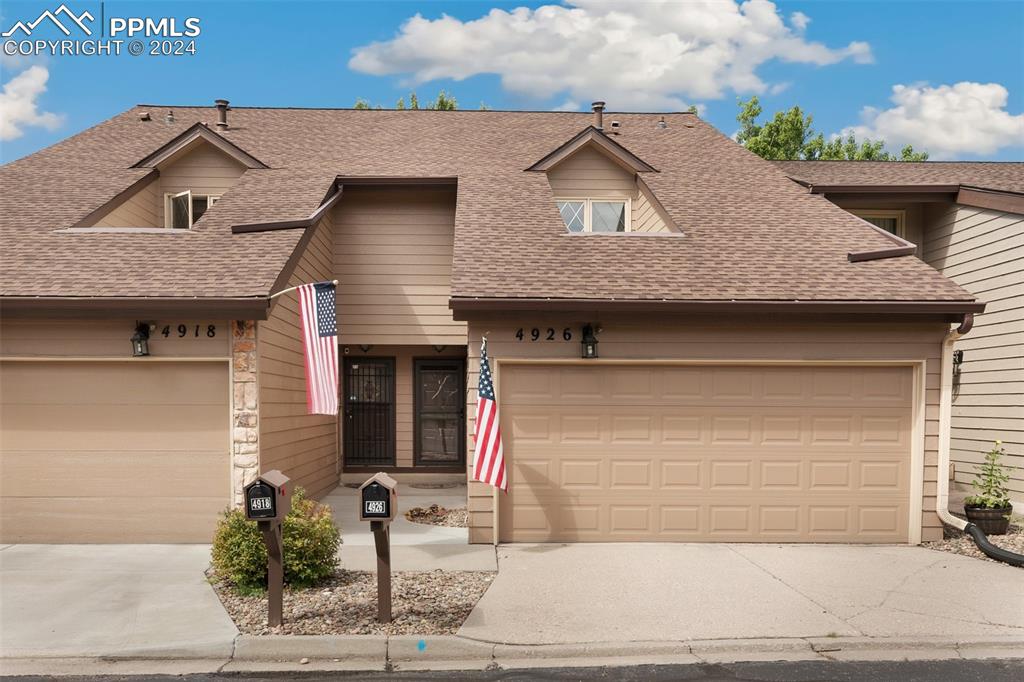 a front view of a house with garage