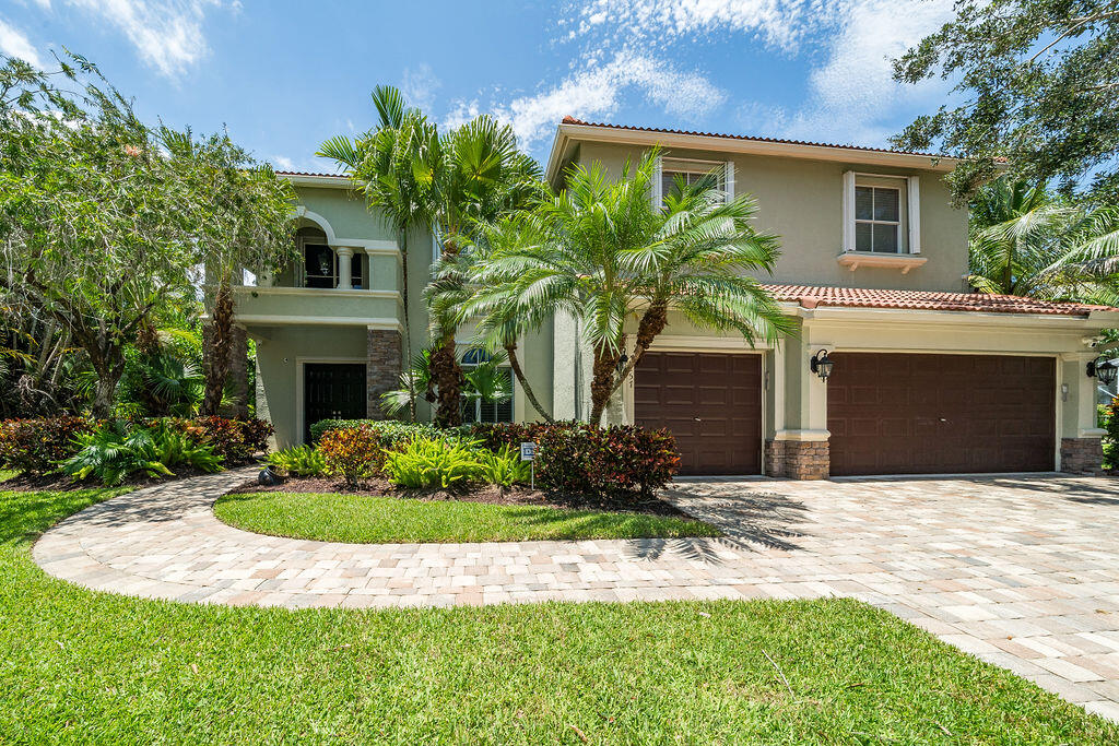 a front view of a house with yard and green space