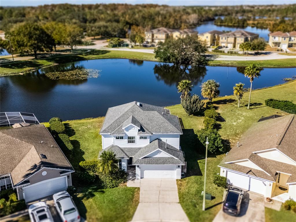 an aerial view of a house with a lake view