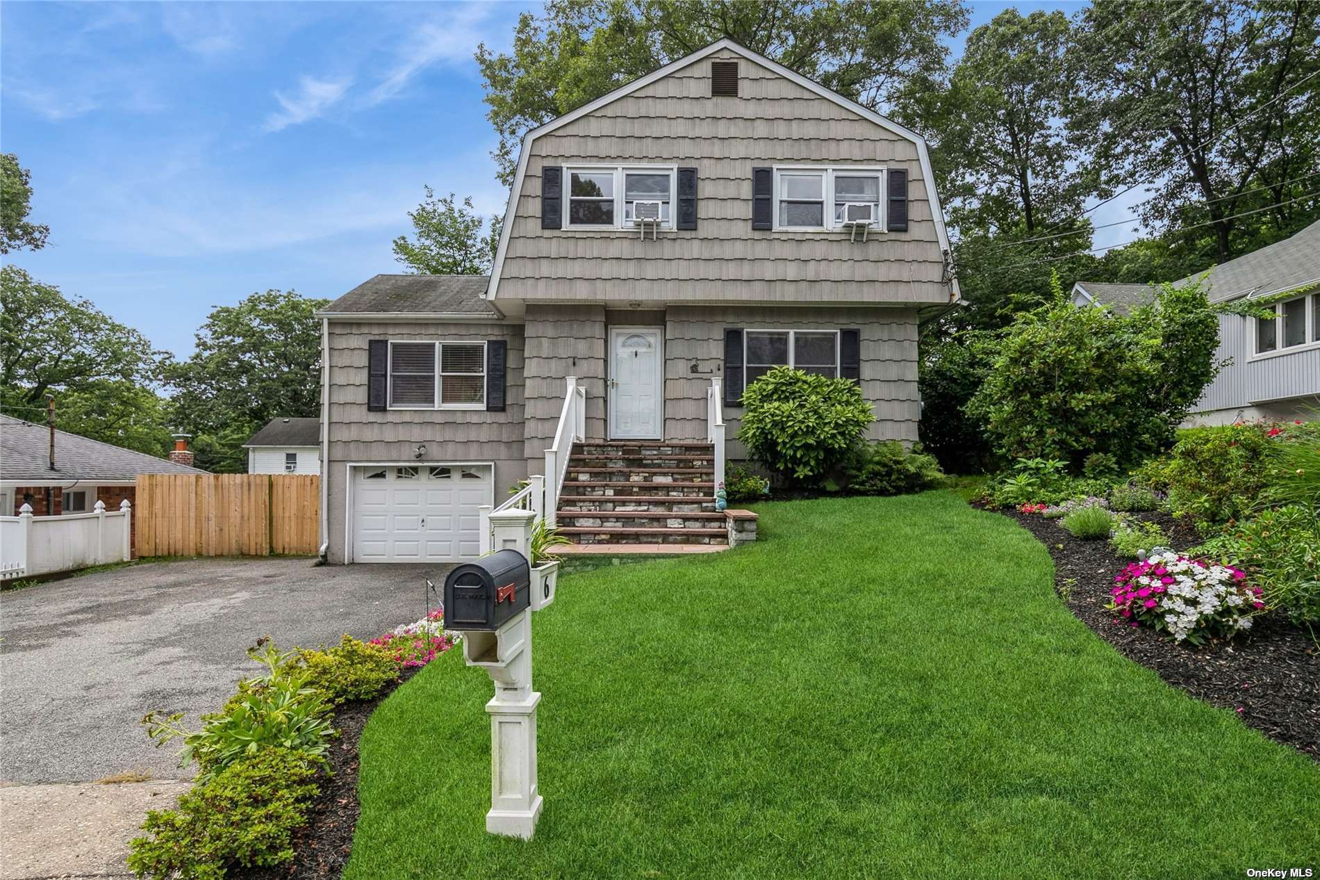 a front view of a house with a garden