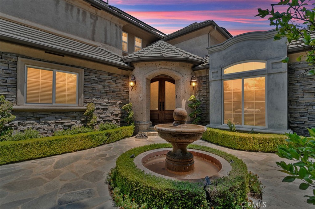 a front view of a house with fountain bath tub and couches