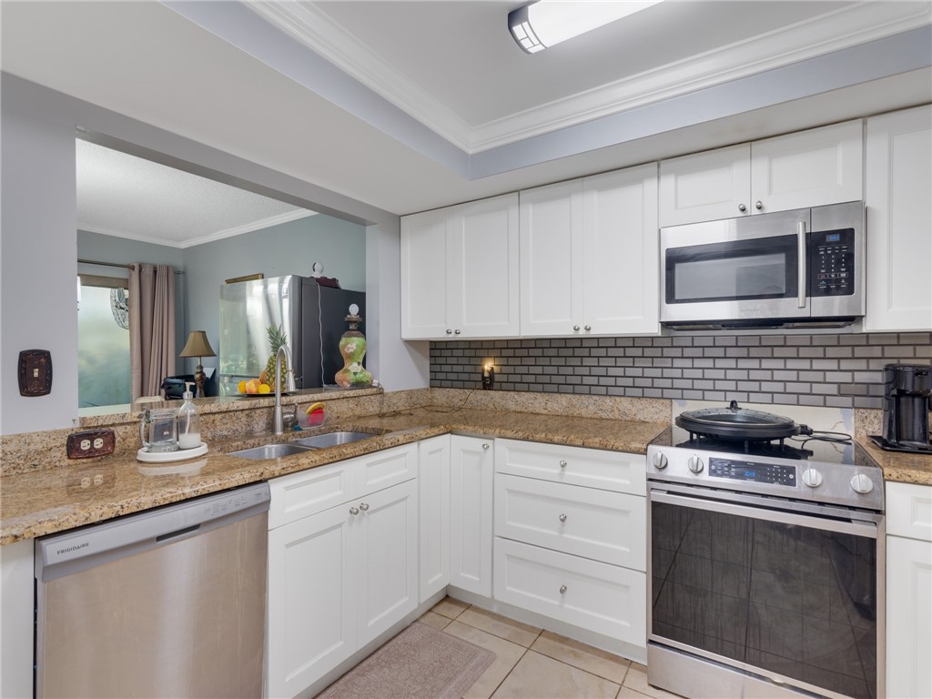 a kitchen with appliances cabinets and a sink