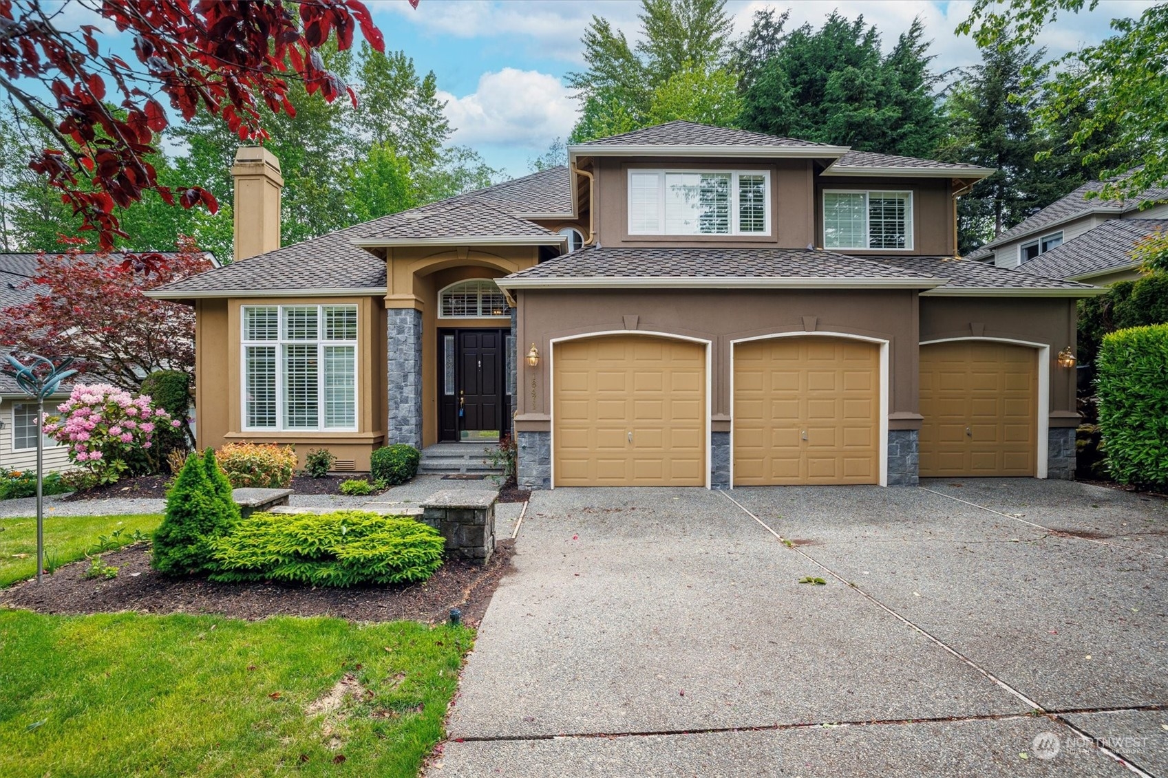 a front view of a house with garden