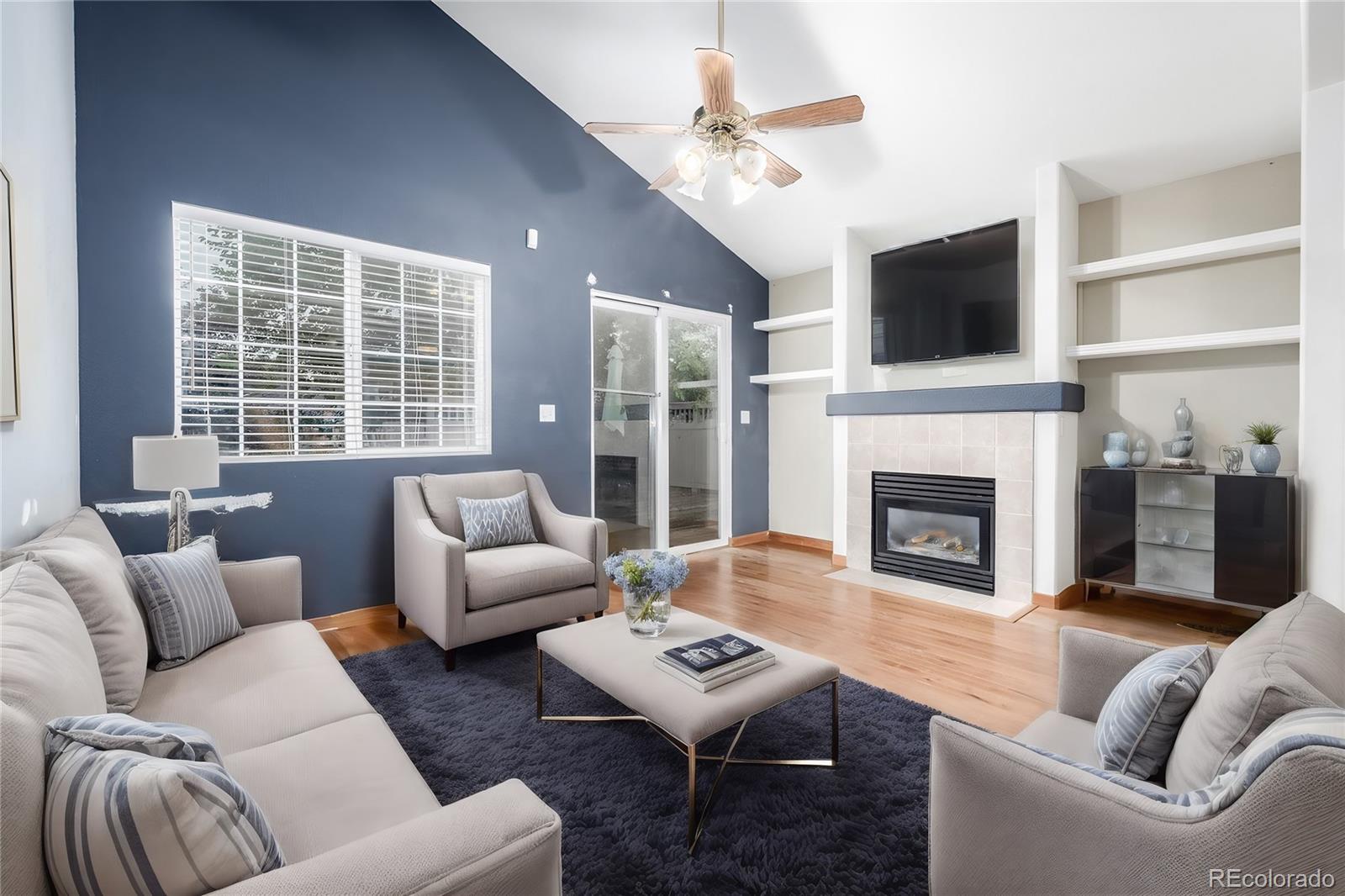 a living room with furniture fireplace and flat screen tv