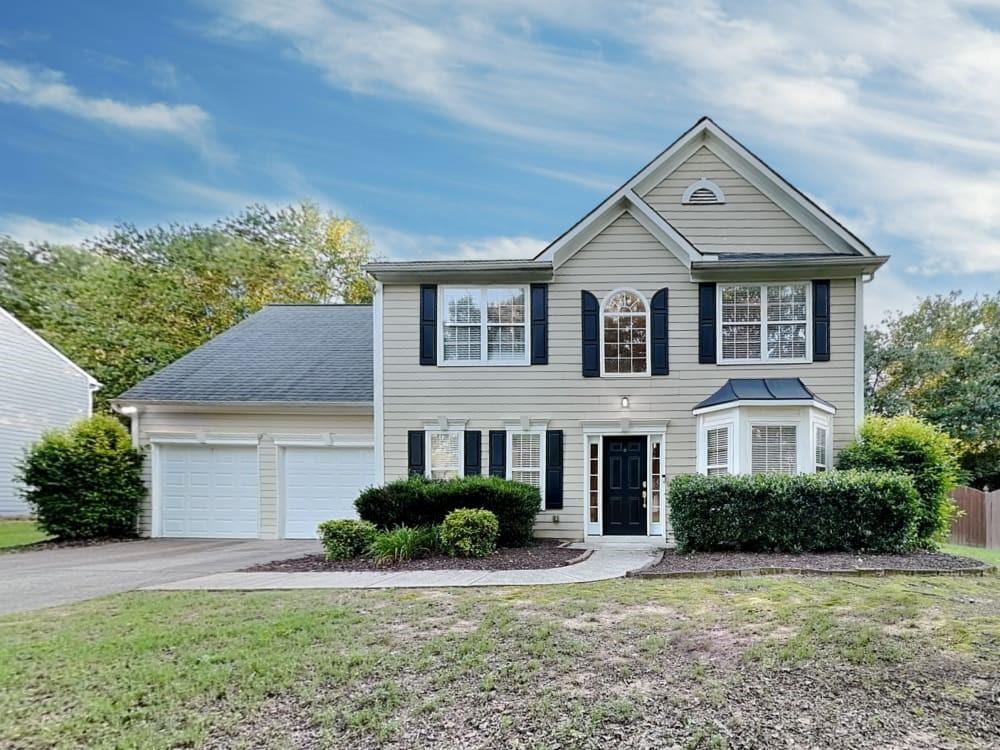 a front view of a house with a yard