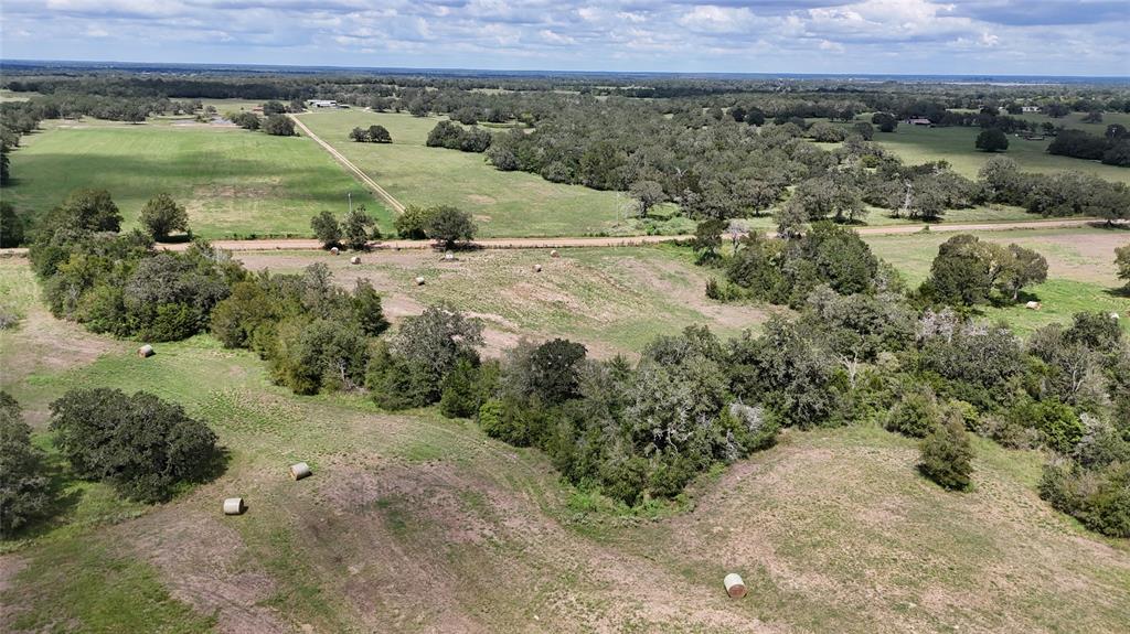 a view of a big yard with a large barn