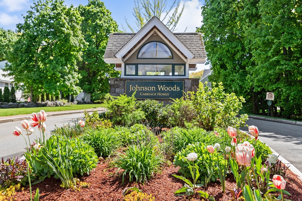 a front view of a house with a yard and fountain in middle