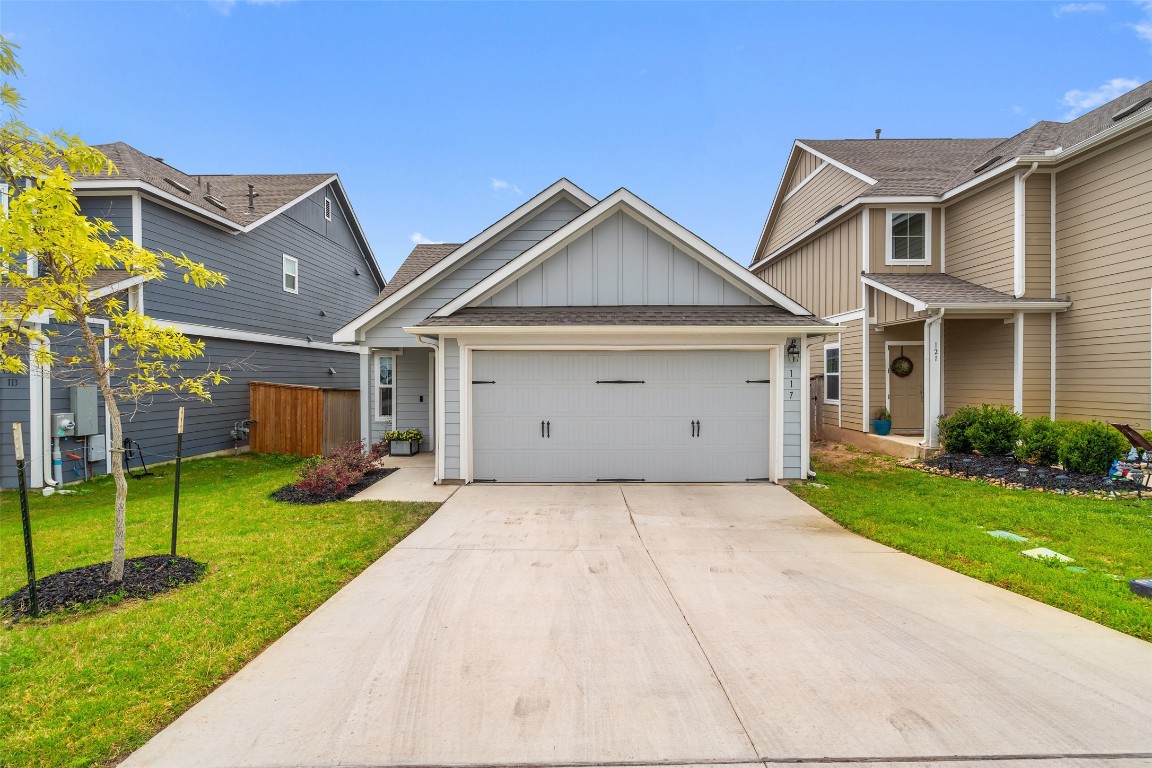 a front view of a house with a yard and garage